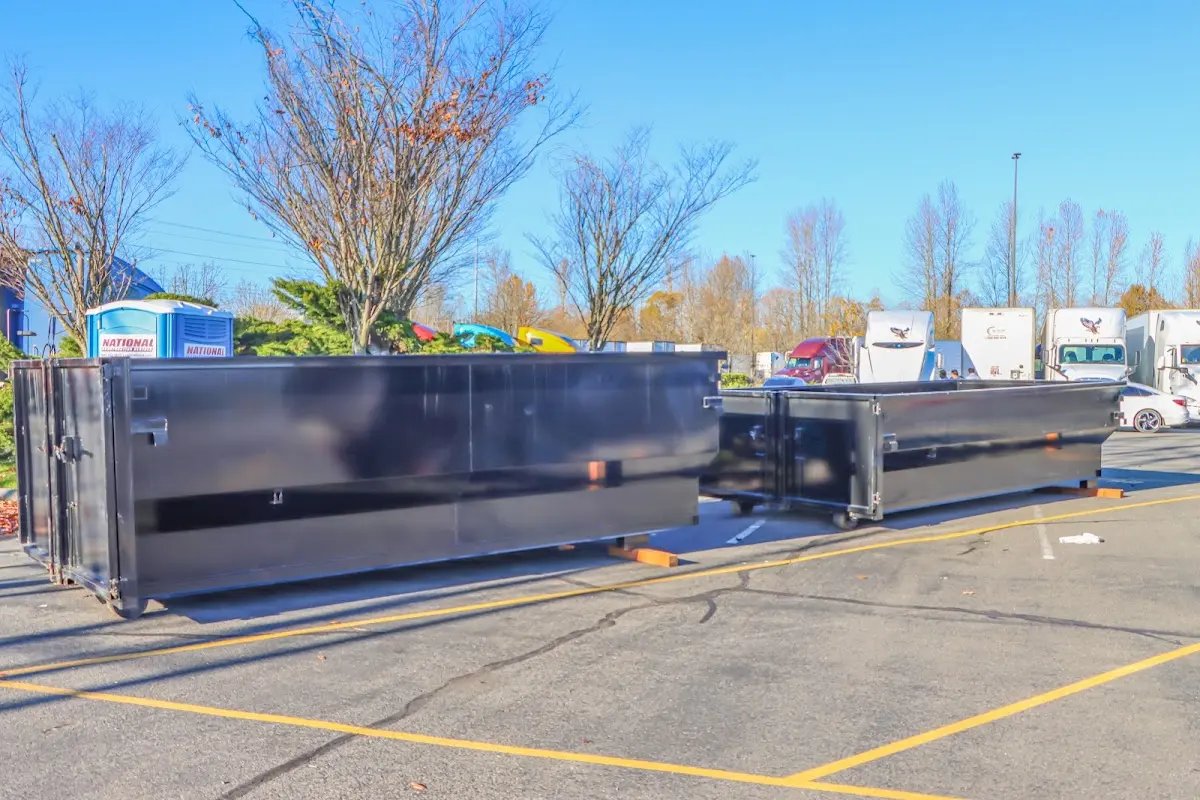 Professional dumpster rental service with roll-off container on residential driveway in Bruce
